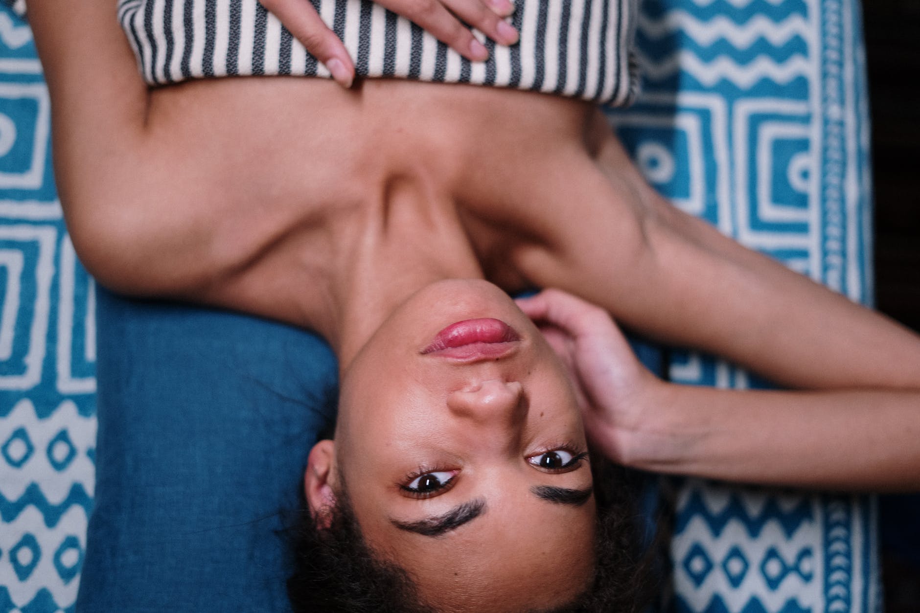 man lying on blue textile