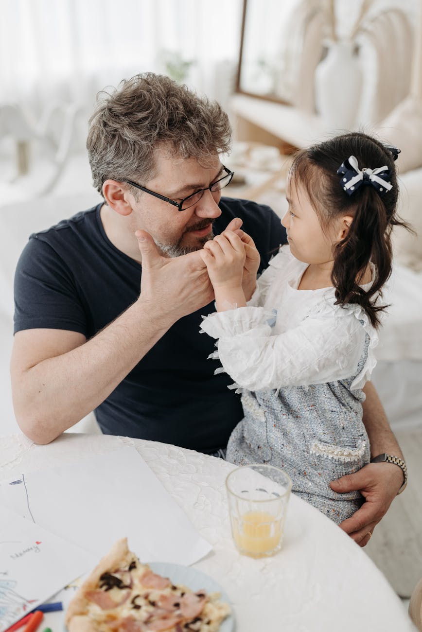 adoptive father with his daughter at the table